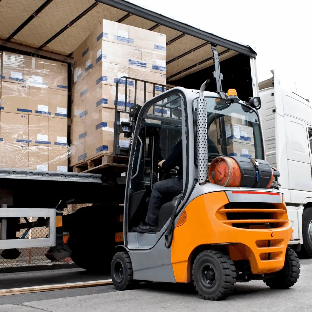 Forklift loading pallets into curtained trailer 